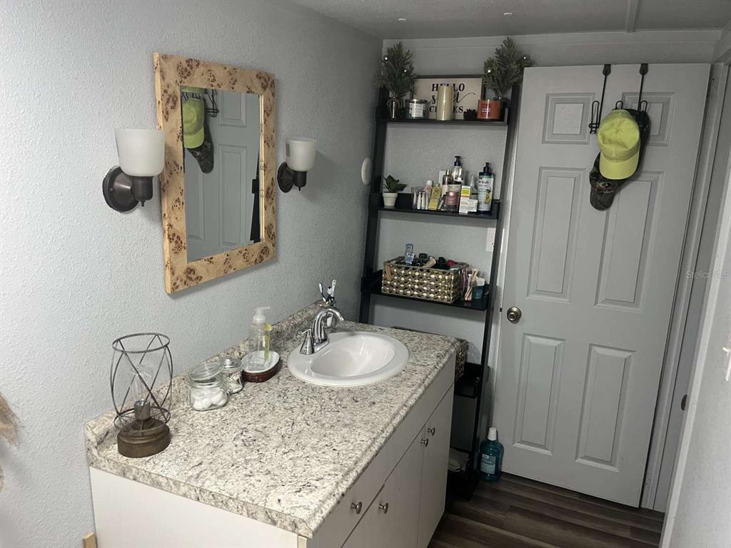 1511 Gaines Road Winter Haven, FL 33880 - Photo 6 of 20 a bathroom with a sink and a mirror