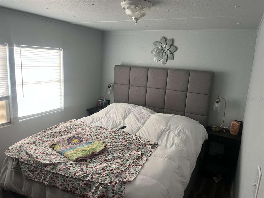 1511 Gaines Road Winter Haven, FL 33880 - Photo 8 of 20 a bedroom with a bed and window