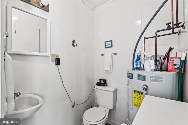 a bedroom with a bed dresser and a window