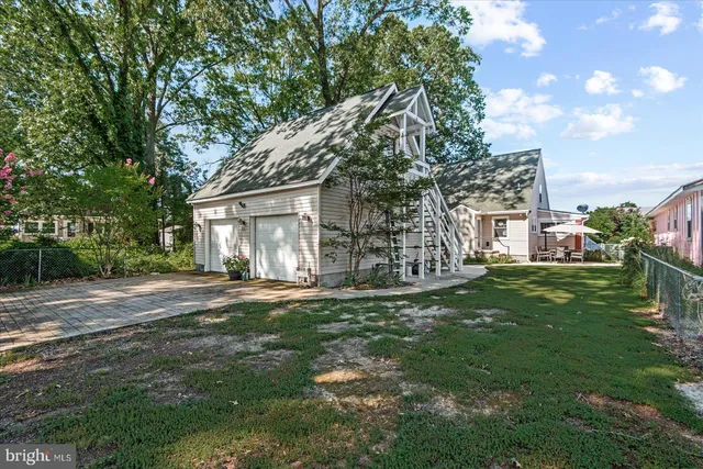a view of a patio with table and chairs under an umbrella