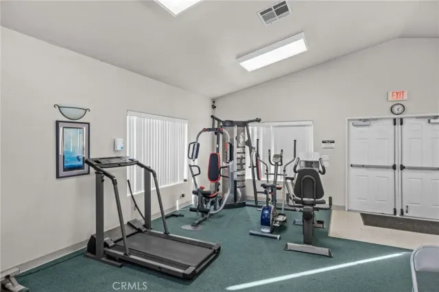 a kitchen with a refrigerator and white cabinets