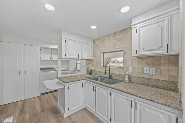 a kitchen with a sink cabinets and window