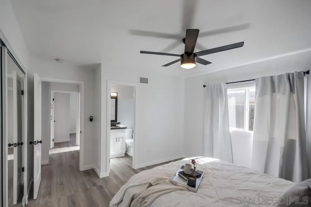 10021 Allenwood Way Santee, CA 92071 - Photo 20 of 30 a bedroom with a bed and a chandelier