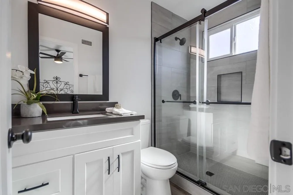 10021 Allenwood Way Santee, CA 92071 - Photo 22 of 30 a bathroom with a sink a toilet and shower