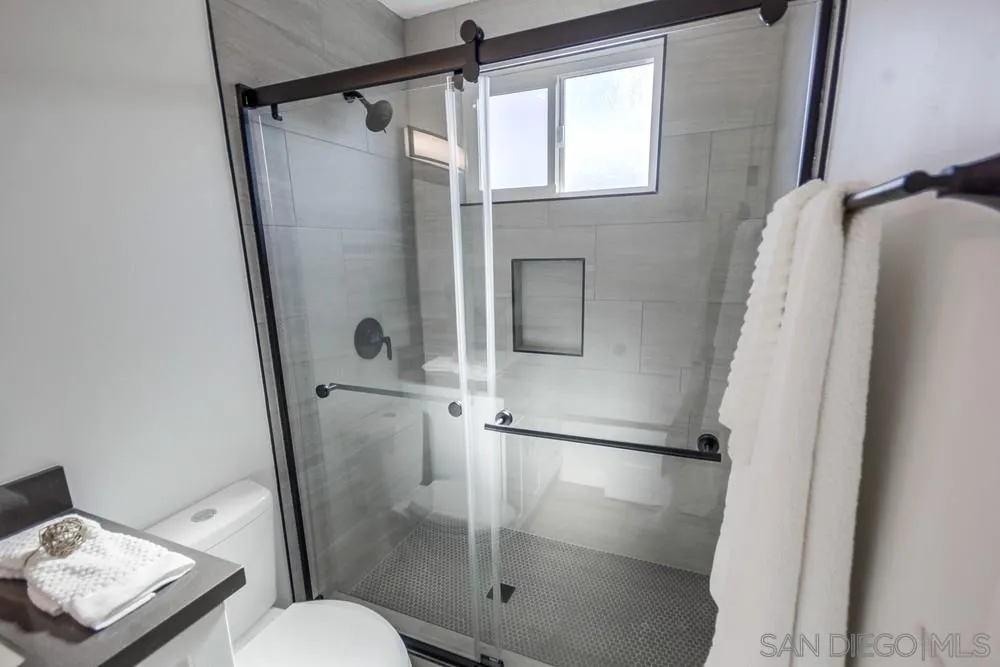 10021 Allenwood Way Santee, CA 92071 - Photo 23 of 30 a bathroom with a shower toilet and sink
