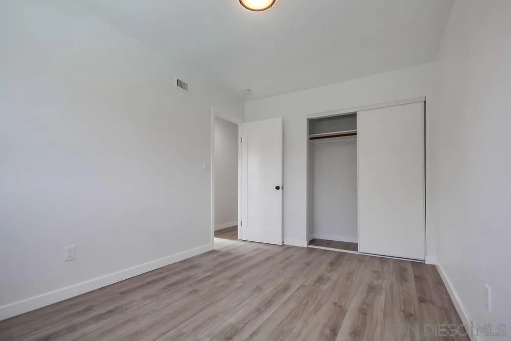 10021 Allenwood Way Santee, CA 92071 - Photo 25 of 30 a view of an empty room with wooden floor and closet