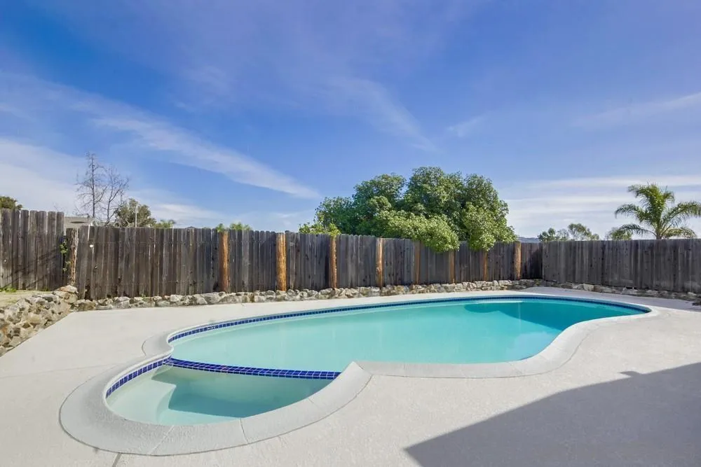 10021 Allenwood Way Santee, CA 92071 - Photo 30 of 30 a view of a swimming pool with a yard and wooden fence