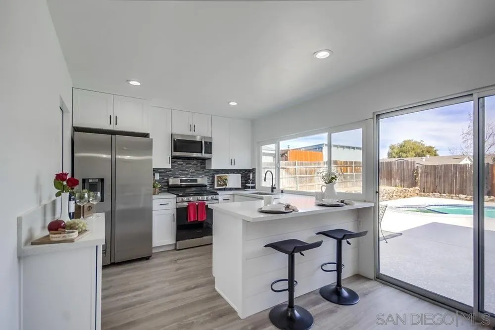 10021 Allenwood Way Santee, CA 92071 - Photo 9 of 30 a kitchen with a refrigerator and a stove top oven