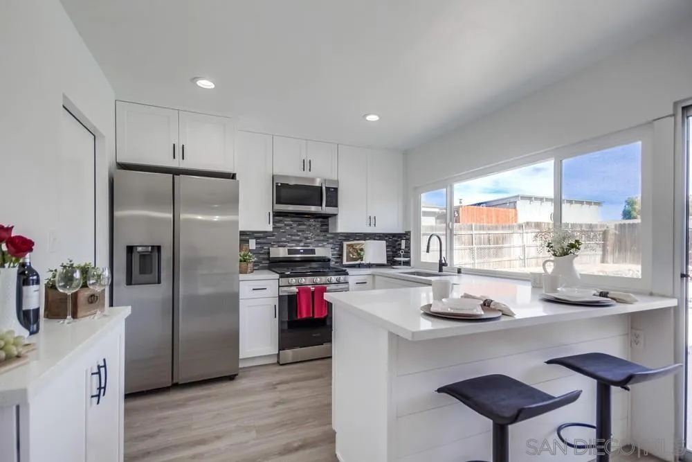 10021 Allenwood Way Santee, CA 92071 - Photo 10 of 30 a kitchen with refrigerator a stove and a wooden floor