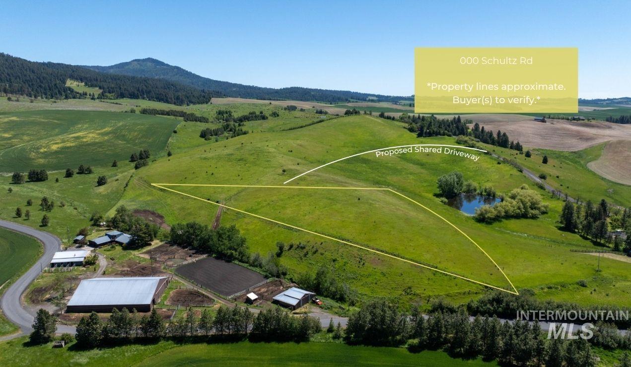 Aerial overview of property's location featuring property parcel outlined and a mountain backdrop