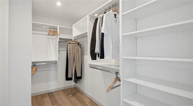 a view of walk in closet with empty racks
