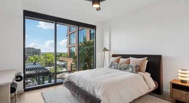 a bedroom with a large bed and a large window