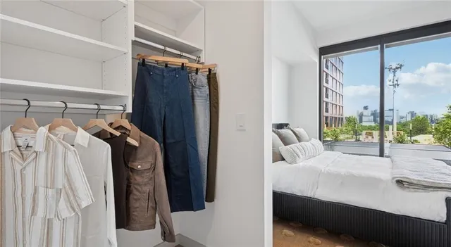 a bedroom with a bed and a mirror