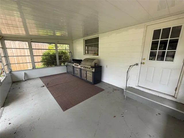 a view of an empty room with window and cabinet