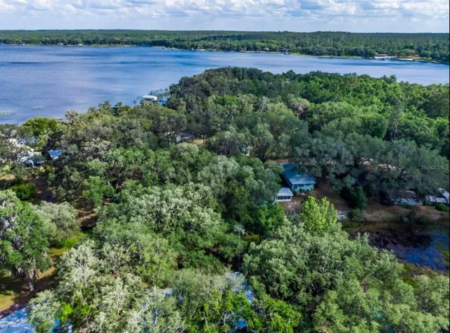 an aerial view of a houses with outdoor space and a yard