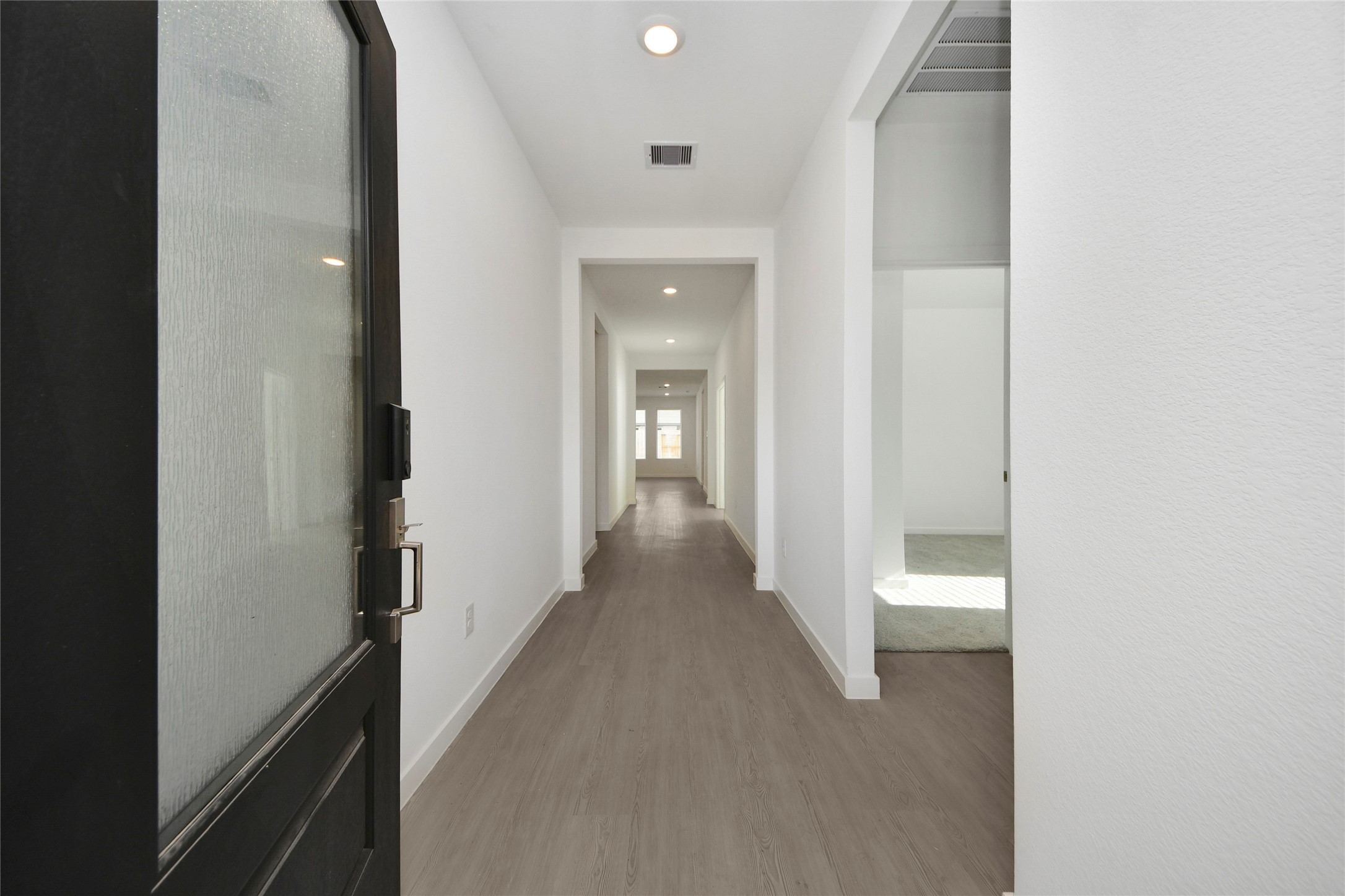 26418 Virginia Wild Rye Lane Katy, TX 77493 - Photo 3 of 26 a view of a hallway with wooden floor