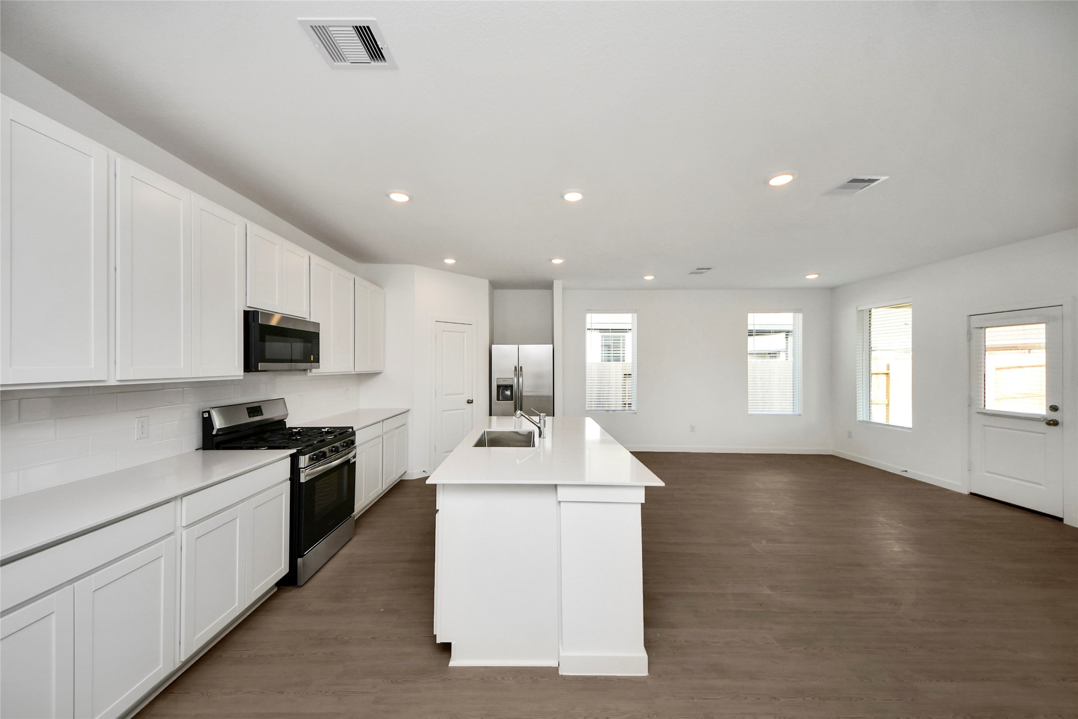 26418 Virginia Wild Rye Lane Katy, TX 77493 - Photo 5 of 26 a kitchen with kitchen island a sink stainless steel appliances and cabinets