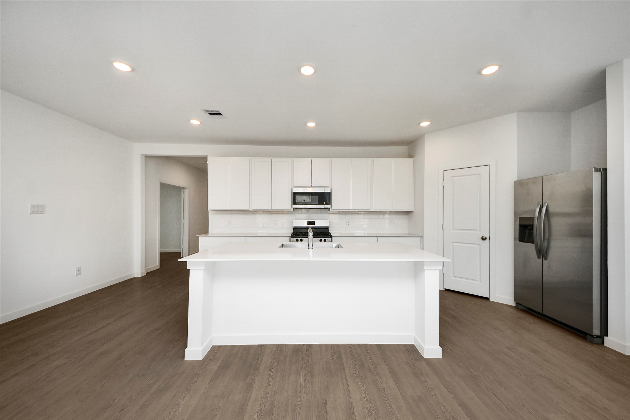 26418 Virginia Wild Rye Lane Katy, TX 77493 - Photo 7 of 26 a view of kitchen with stainless steel appliances refrigerator stove microwave and cabinets