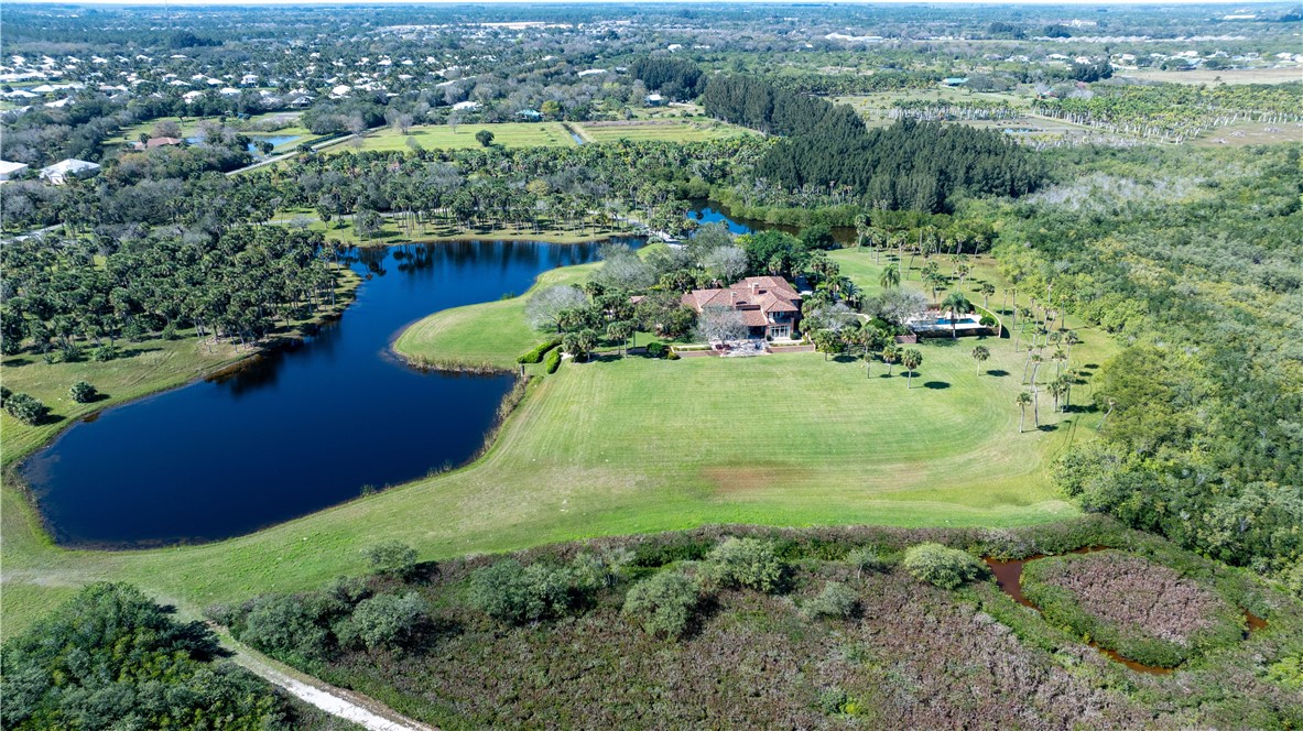 2350 Quay Dock Road Vero Beach, FL 32967 - Photo 30 of 33 an aerial view of a house with a yard and lake view