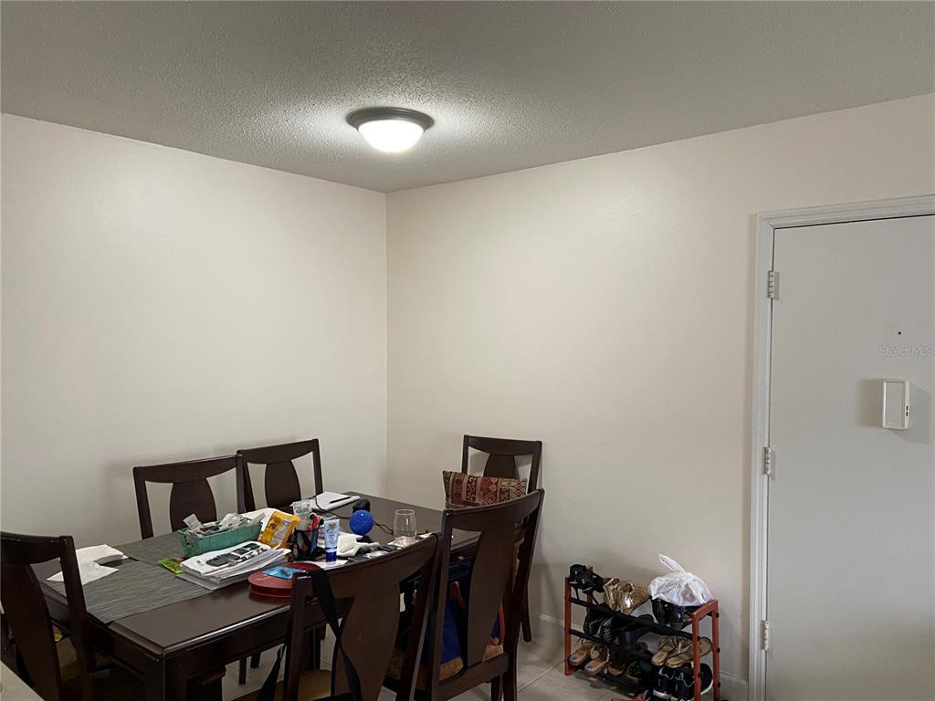 1700 Southwest 16th Court, Unit E8 Gainesville, FL 32608 - Photo 6 of 9 a view of a dining room with furniture