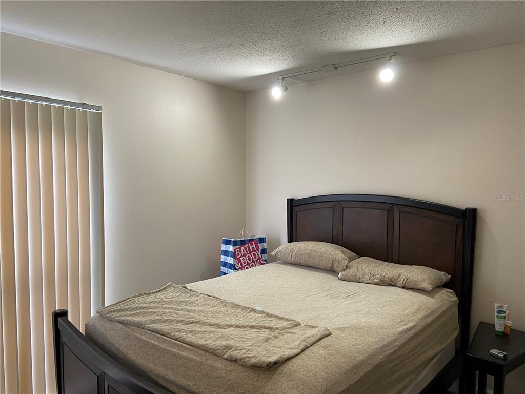 1700 Southwest 16th Court, Unit E8 Gainesville, FL 32608 - Photo 7 of 9 a bedroom with a bed and a window
