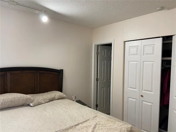 a bedroom with a bed and a closet