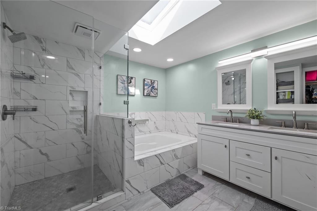 2348 John Thompson Road Graham, NC 27253 - Photo 17 of 34 Updated primary bathroom with tiled walk in shower and soaking tub