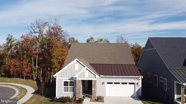 a view of a white house with a yard and plants