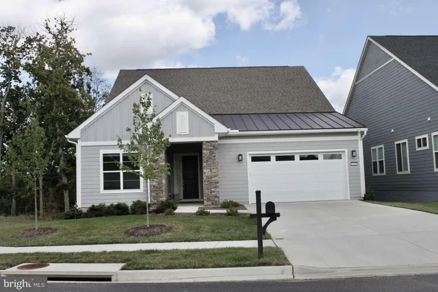 a view of a hallway with wooden floor and a living room