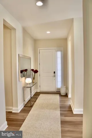 a living room with furniture and floor to ceiling windows
