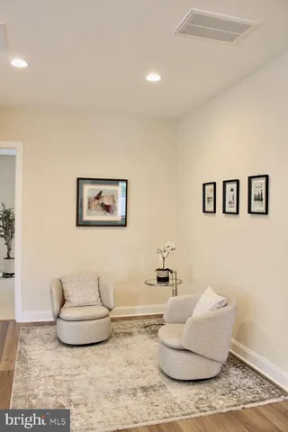 a bedroom with furniture and a flat screen tv