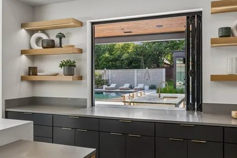 a kitchen with a sink and a potted plant