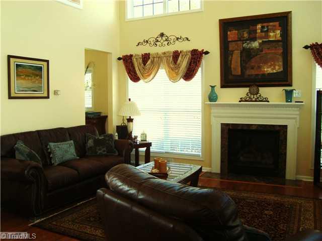 2119 Edgemont Road Greensboro, NC 27406 - Photo 6 of 16 Den/Family/Great Room. A fireplace with gas logs is featured in the Great Room. Note the marble surround on the fireplace and again hardwood floors throughout the main.