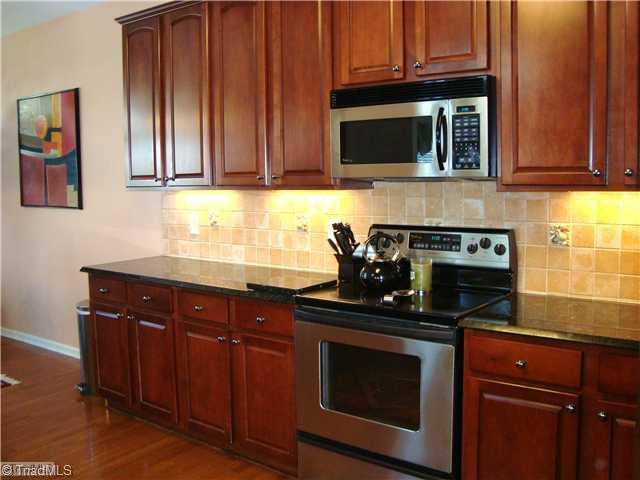 2119 Edgemont Road Greensboro, NC 27406 - Photo 9 of 16 Kitchen. There is nothing missing in this kitchen. Stainless appliances, tile backsplash & granite counters are all here. Look at all the cabinets.