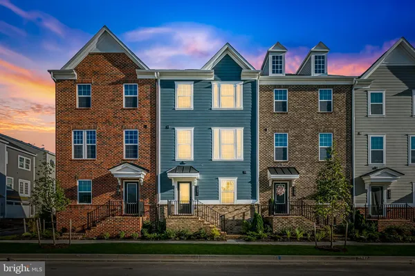 a front view of a residential apartment building with a yard