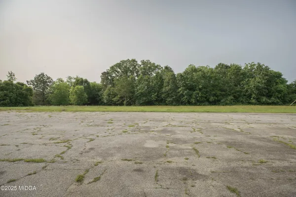 a view of a road with a big yard