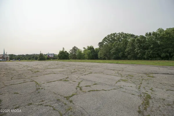 a view of a road with a big yard