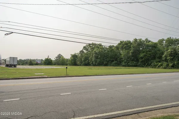 an aerial view of a house with a garden and lake view