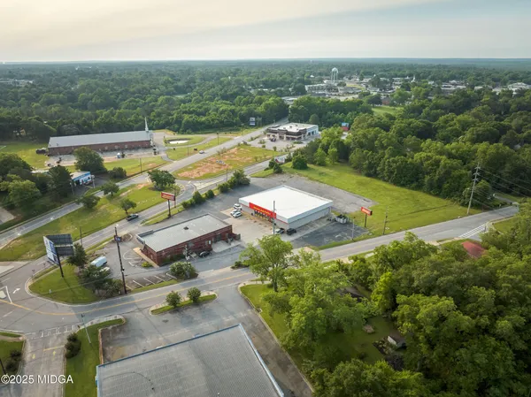 an aerial view of residential houses with outdoor space and lake view