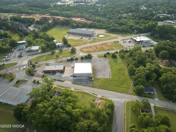 an aerial view of residential houses with outdoor space and river