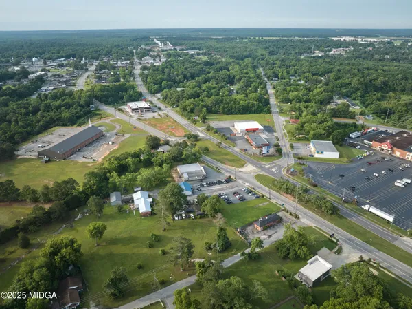 an aerial view of residential houses with outdoor space and swimming pool