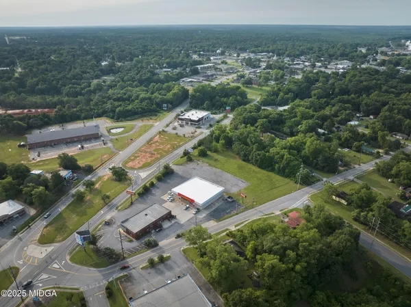 an aerial view of a house with a yard