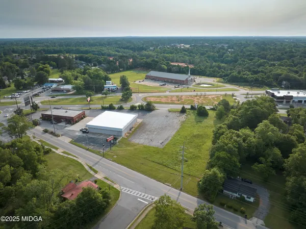 an aerial view of a house with a yard basket ball court and outdoor seating