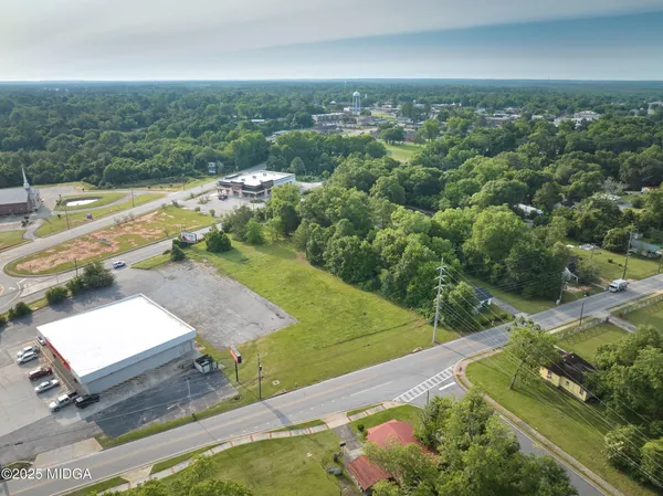 an aerial view of a house with a yard