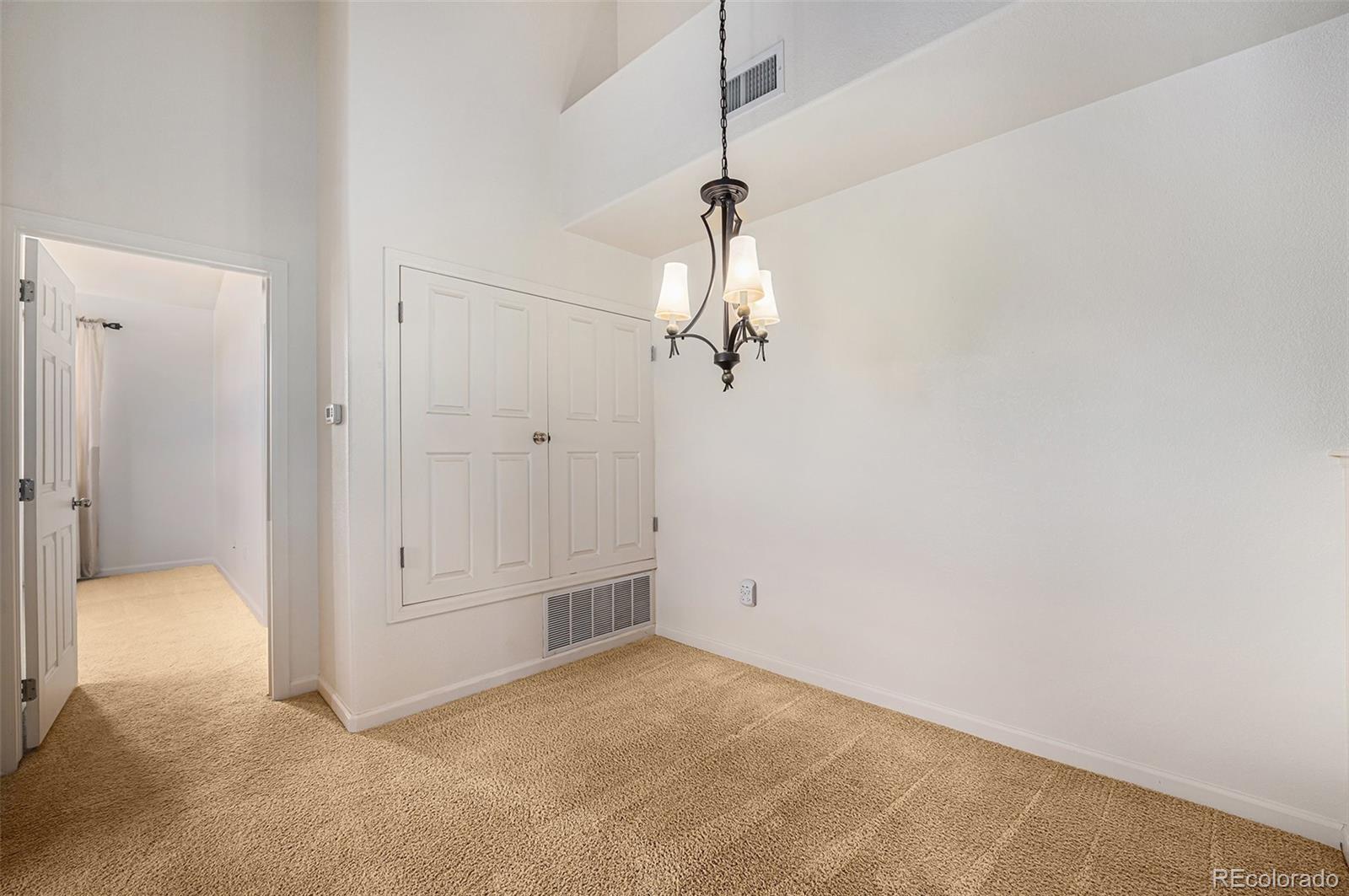 5800 Tower Road, Unit 505 Denver, CO 80249 - Photo 17 of 24 a view of a chandelier in an empty room