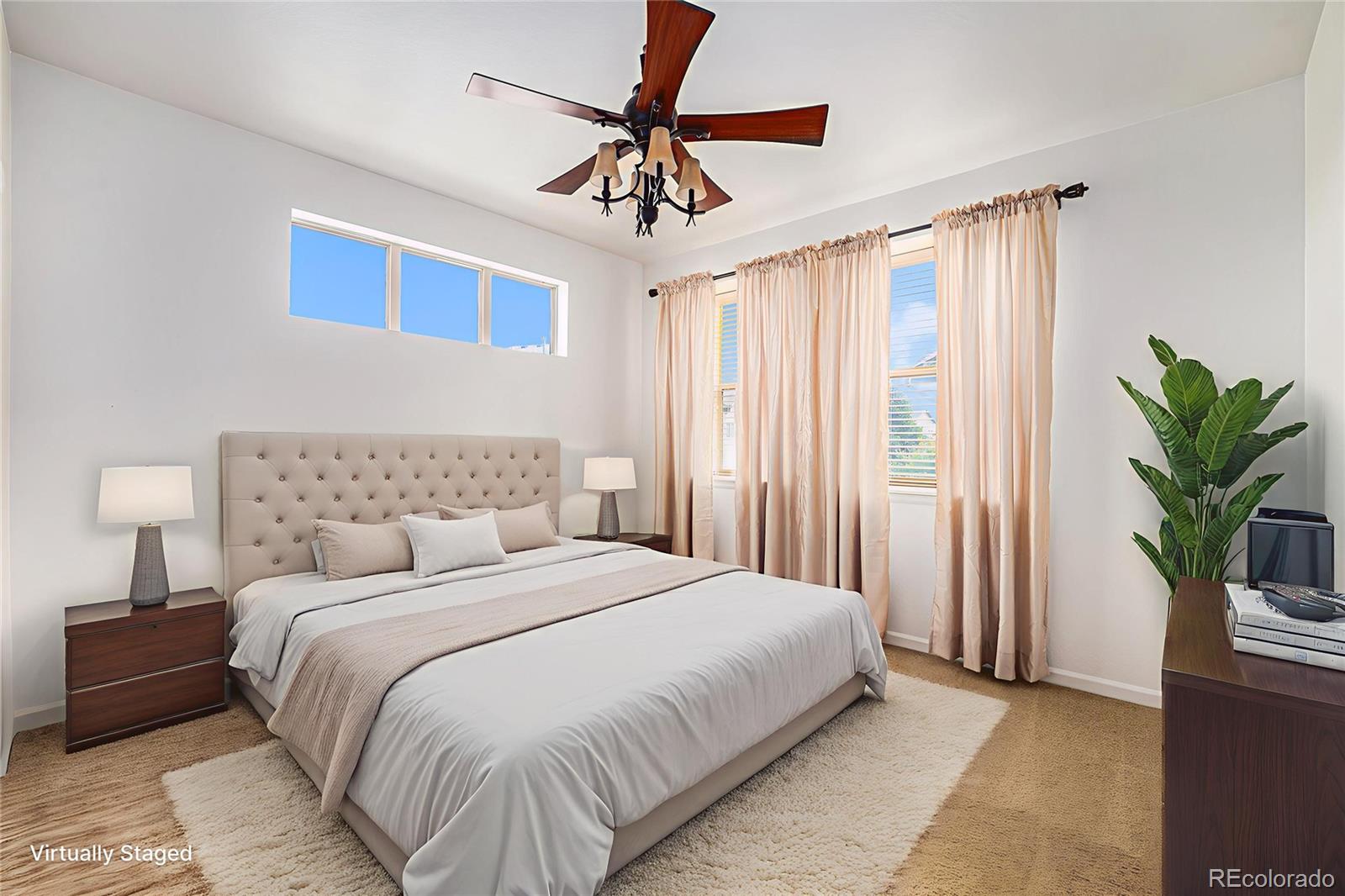 5800 Tower Road, Unit 505 Denver, CO 80249 - Photo 5 of 24 a bedroom with a bed and a potted plant