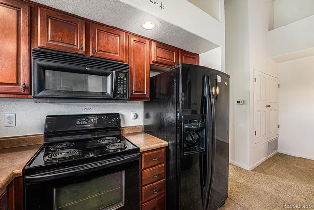 a kitchen with stainless steel appliances and granite countertop wooden cabinets