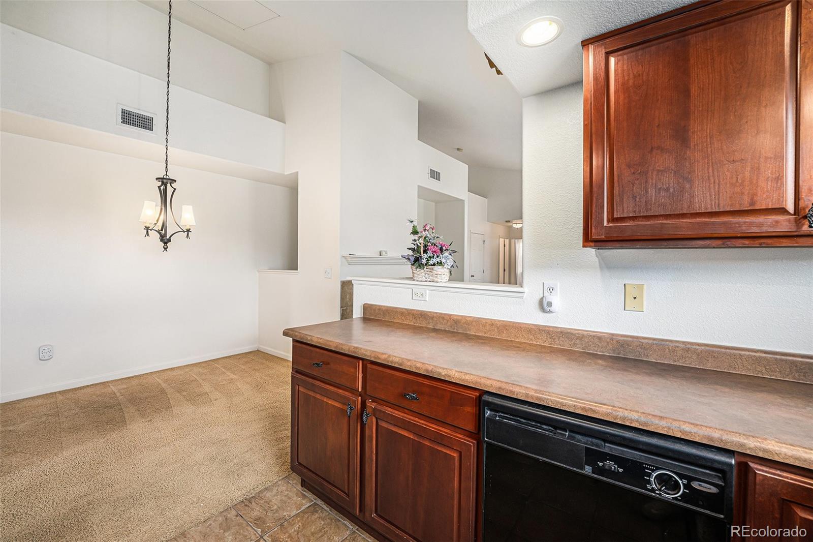 5800 Tower Road, Unit 505 Denver, CO 80249 - Photo 8 of 24 a kitchen with stainless steel appliances granite countertop a sink and cabinets
