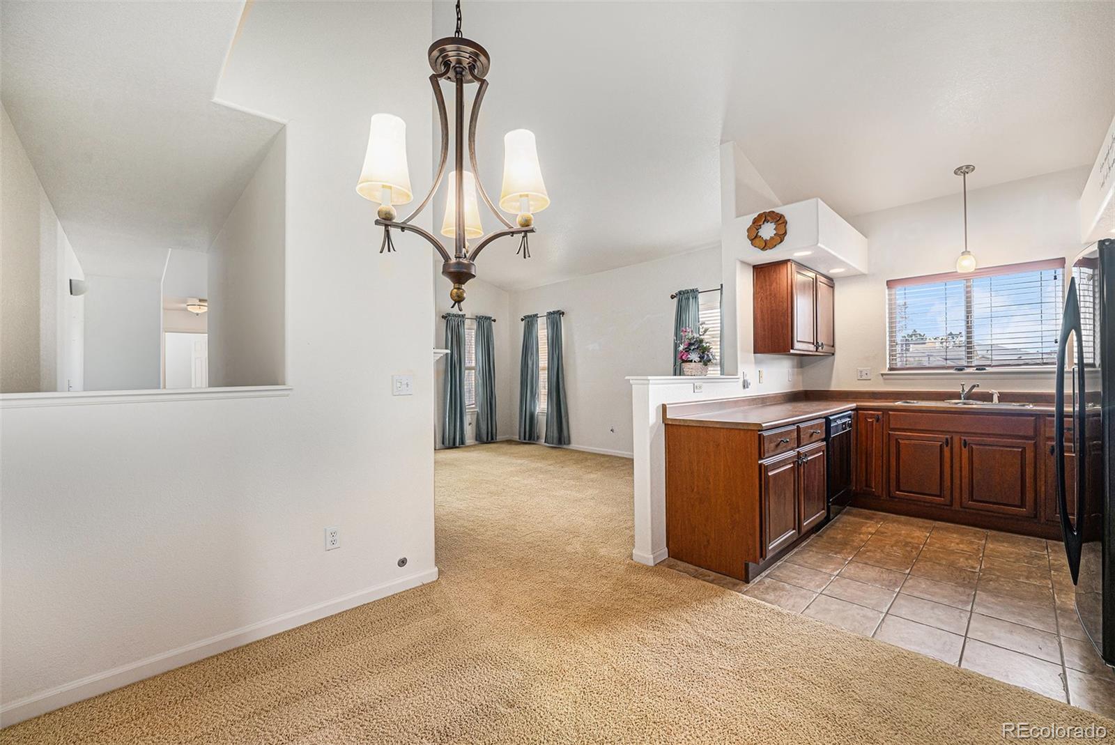 5800 Tower Road, Unit 505 Denver, CO 80249 - Photo 10 of 24 a kitchen with stainless steel appliances granite countertop a sink a stove and a refrigerator