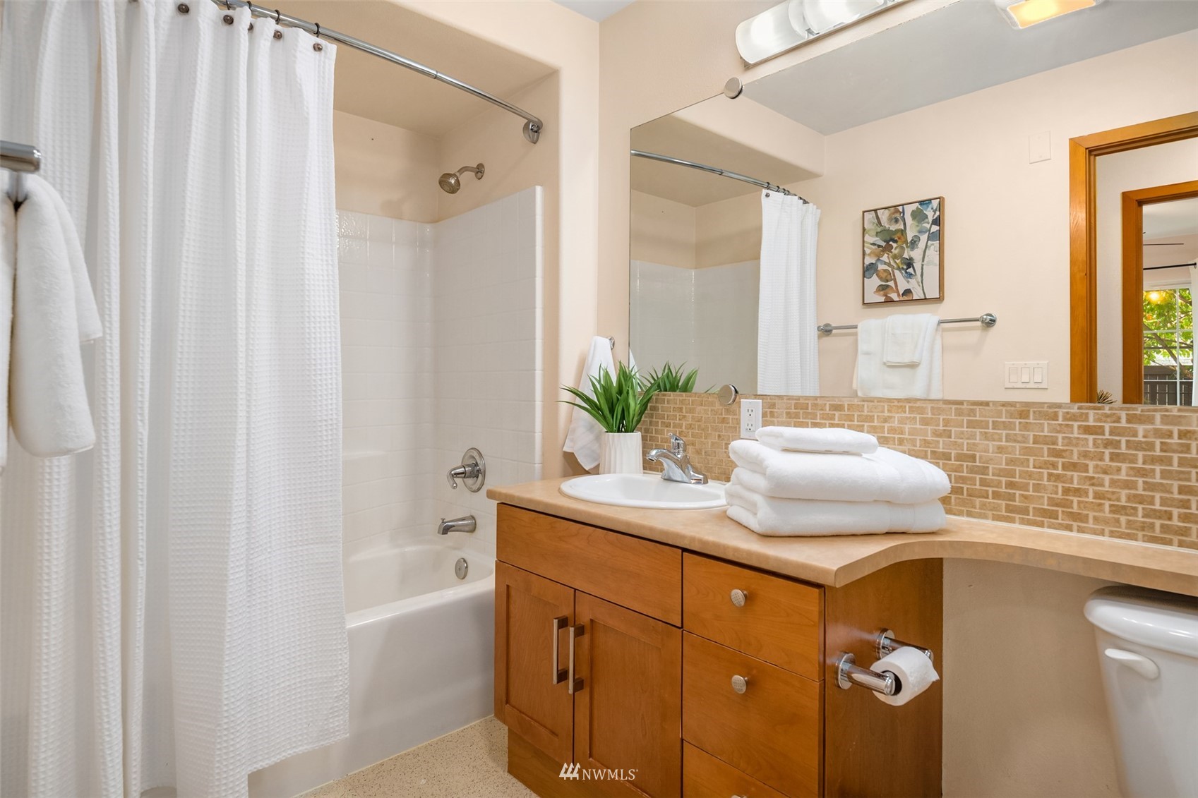 3015 Southwest Avalon Way, Unit 106 Seattle, WA 98126 - Photo 13 of 20 a bathroom with a sink vanity granite tub and shower